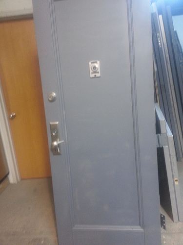 A Kalamein Apt door with recessed panel and door chime peep hole, mortise lockset and top tubular deadbolt lock in brushed chrome : door unpainted